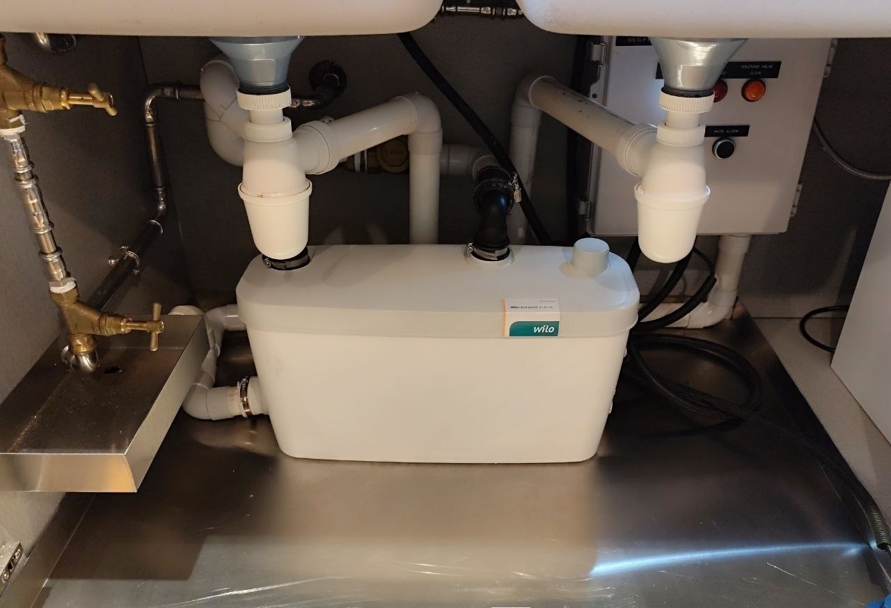 Wilo pantry pump with leak sensor, solenoid valve and customised control panel under a pantry cabinet
